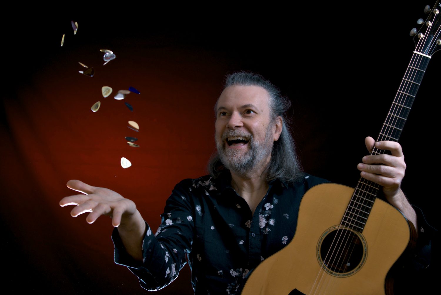 A person throws guitar picks into the air.